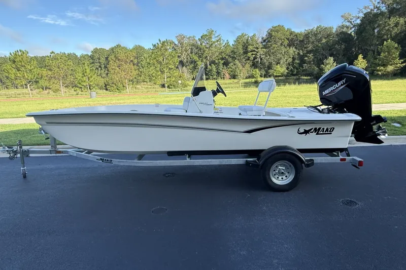 The Image of 2027 Mako Pro Skiff 17 CC boat on trailer, parked outdoors. - 0