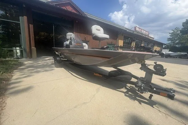 The Image of 2027 Tracker Bass Tracker Classic Limited boat on trailer outside service center. - 0