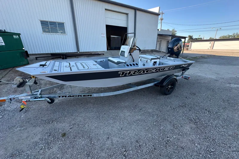 The Image of 2027 Tracker Bass Tracker Classic CC boat on trailer, parked outside industrial building. - 0