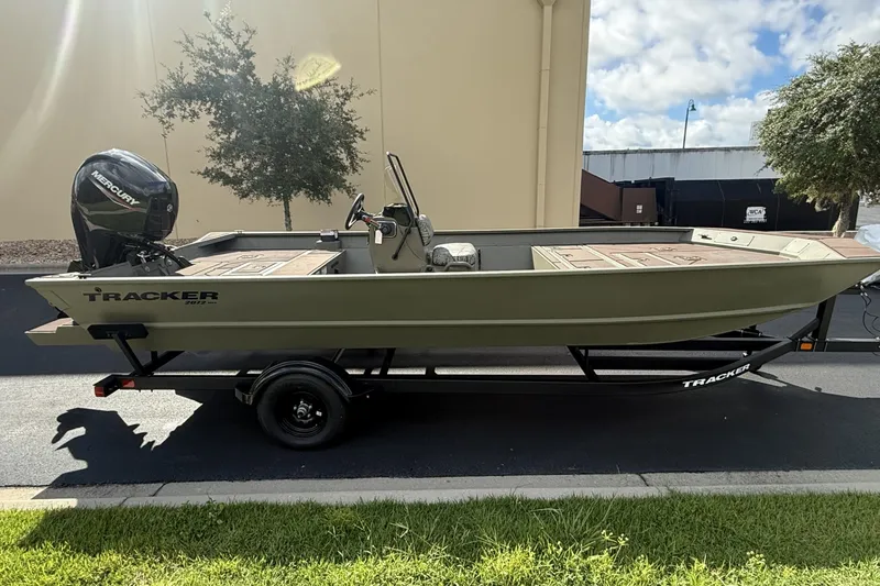 The Image of 2027 Tracker Grizzly 2072 CC boat on trailer, parked outdoors. - 0