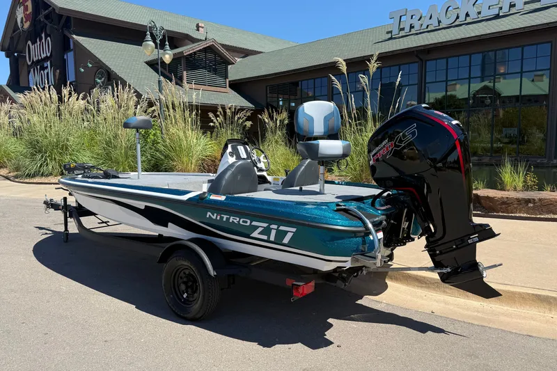 Slide: The Image of 2027 Nitro Z17 boat with Mercury engine parked outside a store. - 2