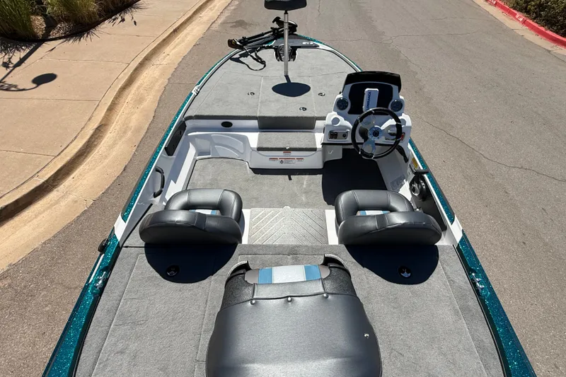Slide: The Image of 2027 Nitro Z17 boat interior with steering wheel and seating on a sunny day. - 12
