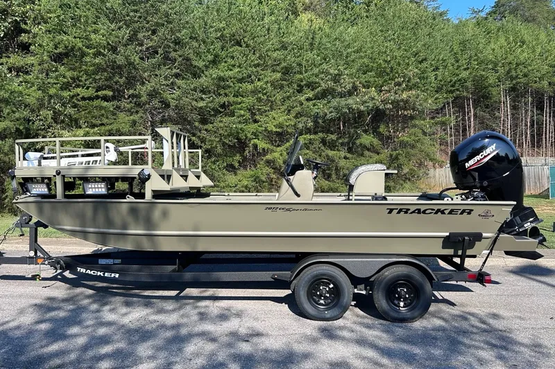 The Image of 2027 Tracker Grizzly 2072 CC Sportsman boat on trailer, parked outdoors. - 0