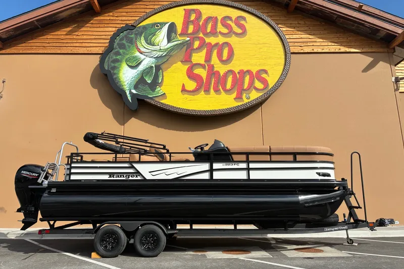 The Image of 2026 Ranger 223FC boat displayed outside Bass Pro Shops store. - 0