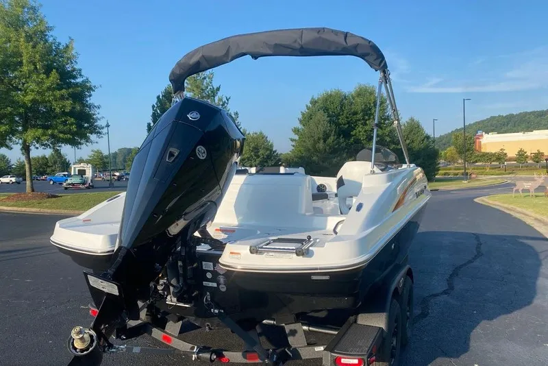 Slide: The Image of 2027 Tahoe 2150 boat with outboard motor on a trailer in a parking lot. - 3