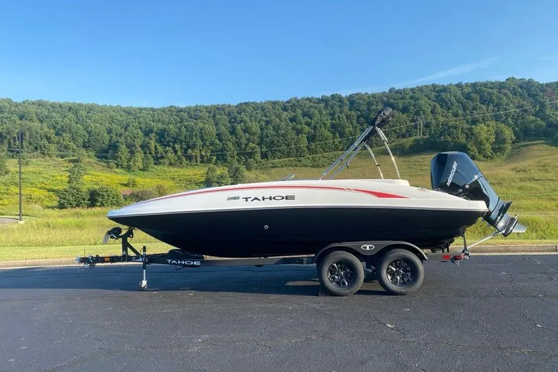 Slide: The Image of 2027 Tahoe 2150 boat on trailer, scenic background, clear sky. - 1