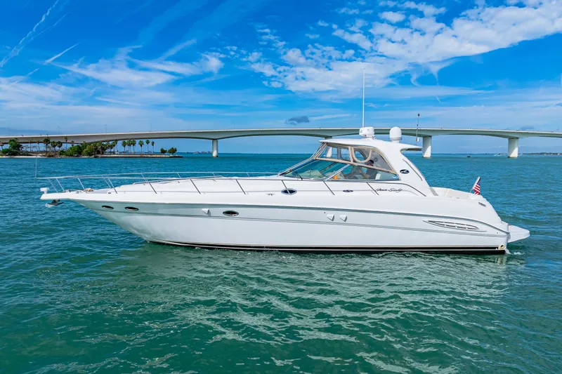 Slide: The Image of 2002 Sea Ray Sundancer 460 yacht cruising on clear blue waters under a sunny sky. - 26
