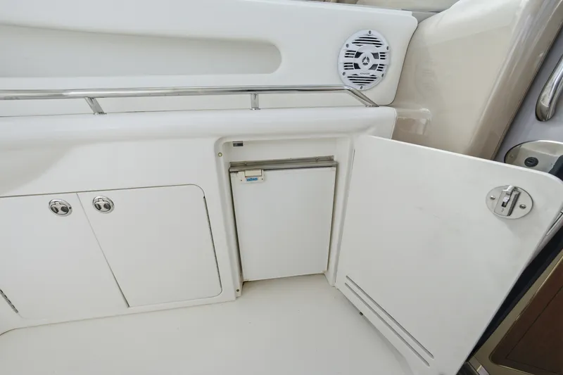 Slide: The Image of 2002 Sea Ray Sundancer 460 yacht interior with open storage compartment and speaker. - 16