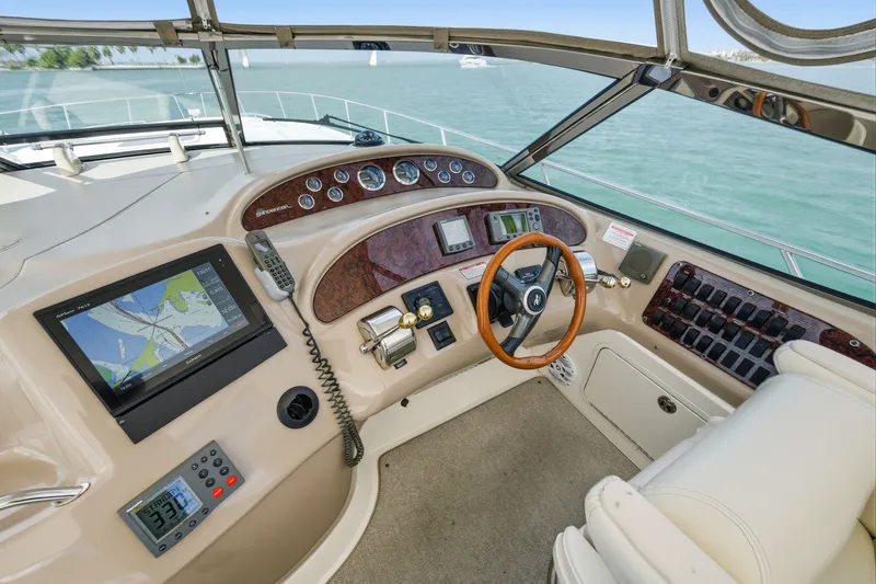 Slide: The Image of Cockpit of 2002 Sea Ray Sundancer 460 yacht with navigation equipment and steering wheel. - 14