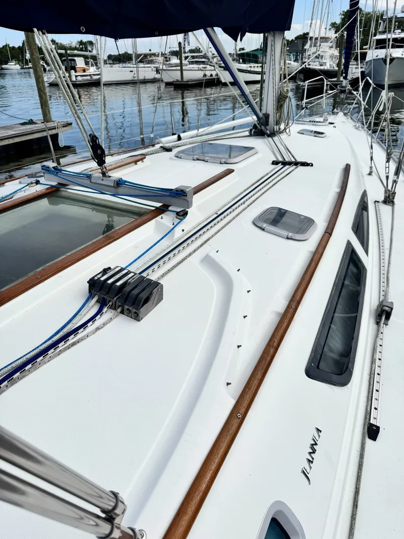 Slide: The Image of The image shows the deck of a 2001 Jeanneau Sun Odyssey 40 at a marina. - 25