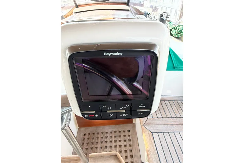 Slide: The Image of Raymarine navigation system on 1983 Tayana Aft Cockpit yacht, featuring control buttons and display. - 22