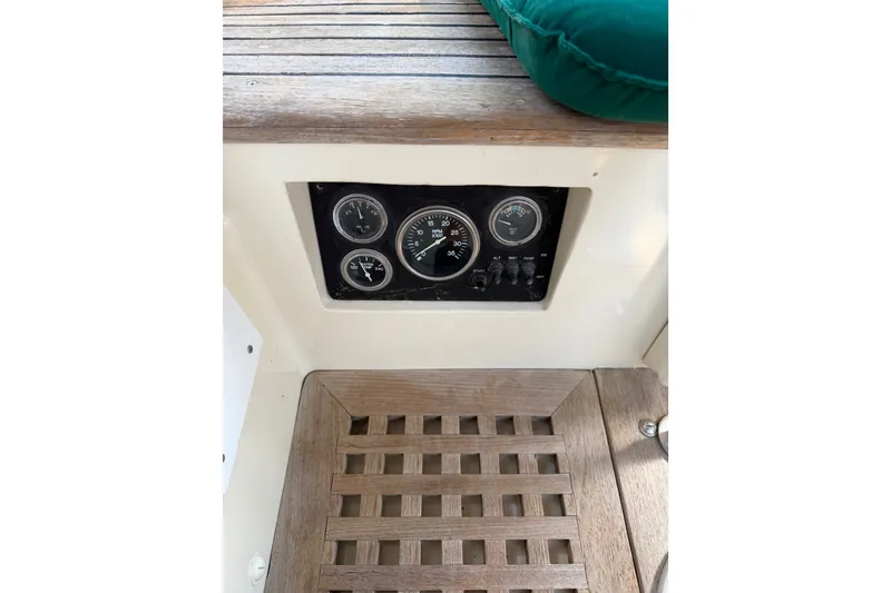 Slide: The Image of 1983 Tayana Aft Cockpit control panel with gauges and wooden flooring. - 23