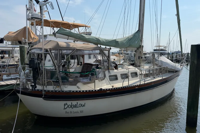 The Image of 1984 Tayana Aft Cockpit sailboat docked at marina, featuring classic design and spacious deck. - 1