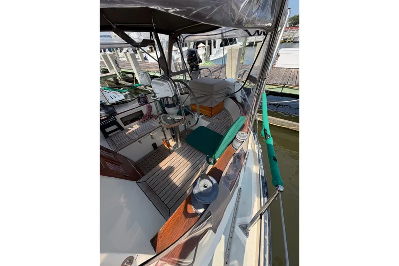 Slide: The Image of 1984 Tayana Aft Cockpit sailboat interior with wooden deck and steering wheel. - 17