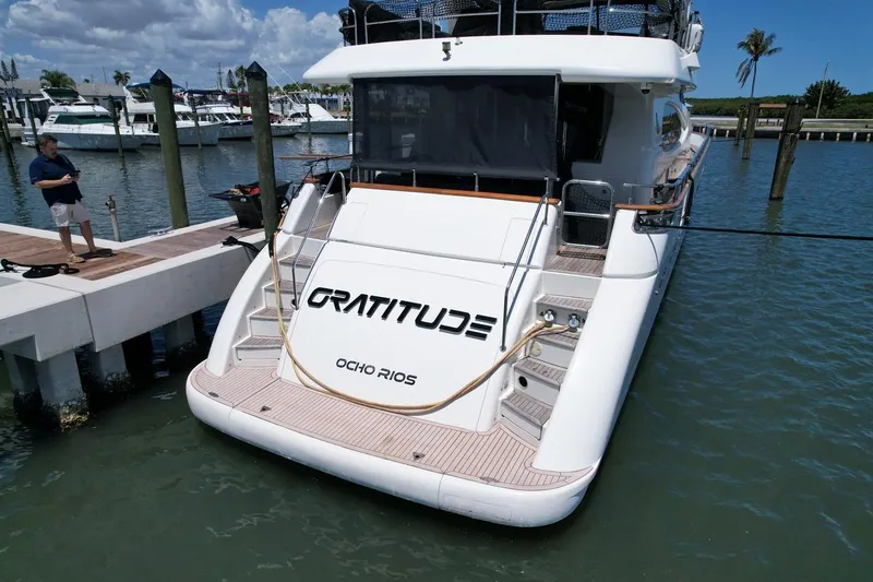 Slide: The Image of Azimut 85 Ultimate yacht docked, rear view, with "Gratitude" and "Ocho Rios" text visible. - 101