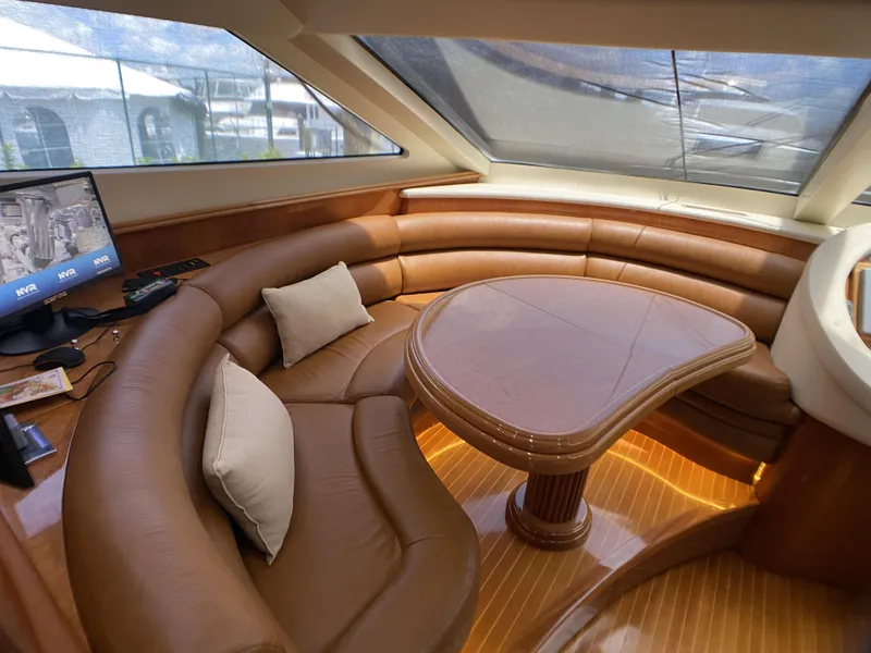 Slide: The Image of Luxurious interior of 1999 Azimut 85 Ultimate yacht with leather seating and wooden table. - 34