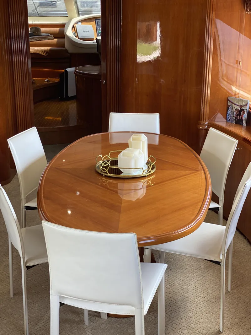 Slide: The Image of Luxurious dining area on 1999 Azimut 85 Ultimate yacht with elegant wooden table and white chairs. - 21
