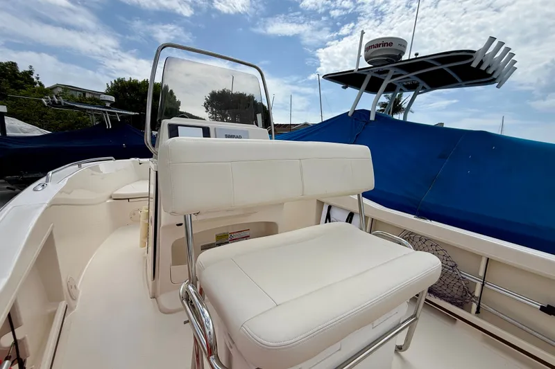 Slide: The Image of 2026 Grady-White Fisherman 180 boat interior with white seating and navigation equipment. - 22