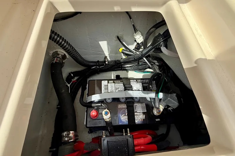 Slide: The Image of Battery compartment of 2026 Grady-White Fisherman 180 boat, showing wiring and connections. - 16