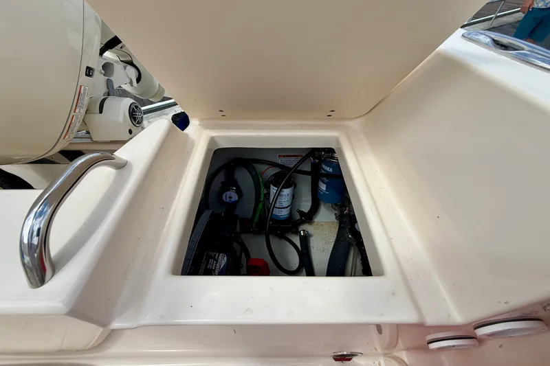 Slide: The Image of 2026 Grady-White Fisherman 180 boat compartment with visible equipment and wiring. - 13