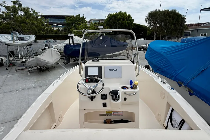 Slide: The Image of 2026 Grady-White Fisherman 180 boat interior with steering console and navigation equipment. - 23