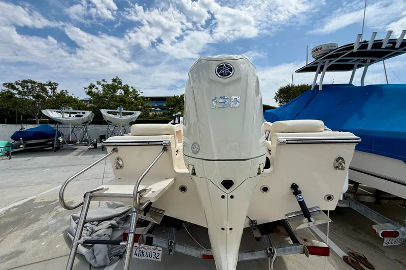 Slide: The Image of 2026 Grady-White Fisherman 180 boat with Yamaha 150 engine, parked outdoors. - 3