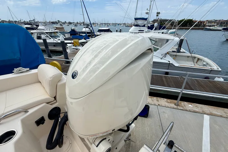 Slide: The Image of 2026 Grady-White Fisherman 180 boat docked at marina with outboard motor. - 24