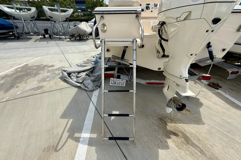 Slide: The Image of 2026 Grady-White Fisherman 180 boat with ladder and outboard motor in a marina. - 28