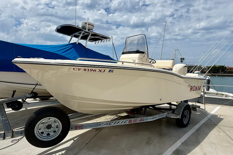 Slide: The Image of 2026 Grady-White Fisherman 180 boat on trailer at marina under cloudy sky. - 1