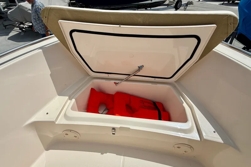 Slide: The Image of Open storage compartment on 2026 Grady-White Fisherman 180 boat with life jackets inside. - 6