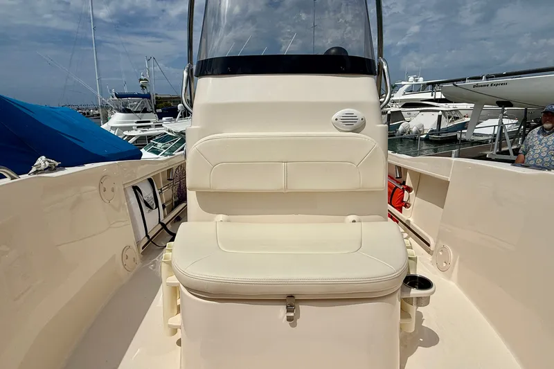 Slide: The Image of 2026 Grady-White Fisherman 180 boat interior with cushioned seating at a marina. - 9