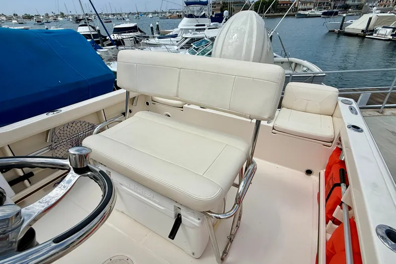 Slide: The Image of 2026 Grady-White Fisherman 180 boat interior with white seating and steering wheel. - 10