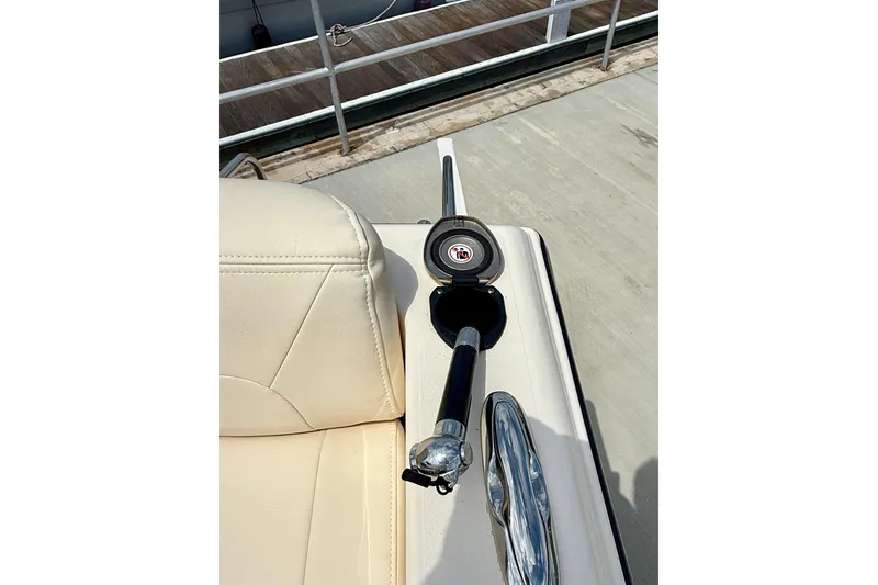 Slide: The Image of 2026 Grady-White Fisherman 180 boat interior with rod holder and beige seating. - 15