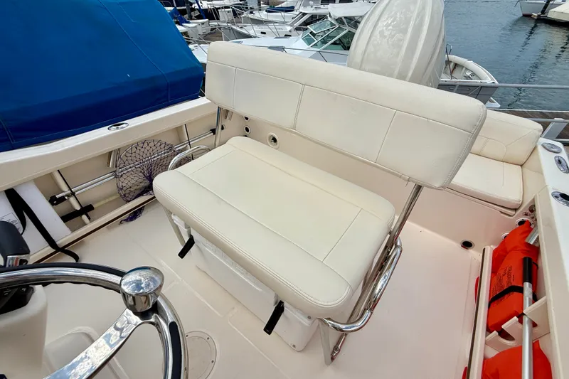 Slide: The Image of 2026 Grady-White Fisherman 180 boat interior with white seating and steering wheel. - 20