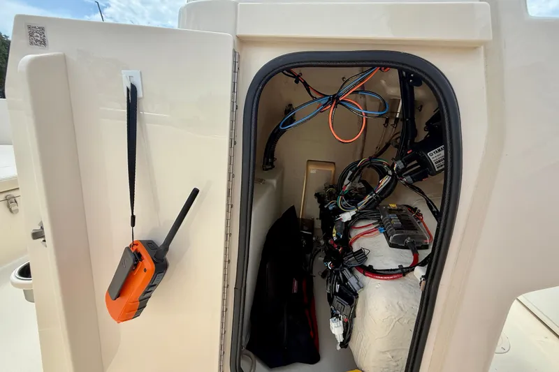 Slide: The Image of Open compartment on 2026 Grady-White Fisherman 180 boat showing wiring and equipment. - 17
