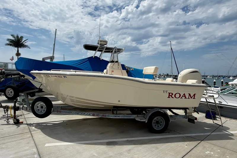 The Image of 2026 Grady-White Fisherman 180 boat on trailer at marina, under cloudy sky. - 0