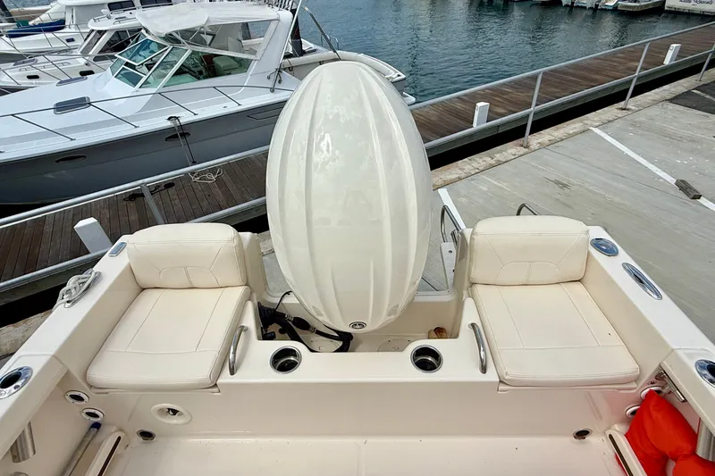 Slide: The Image of 2026 Grady-White Fisherman 180 boat interior with seating and engine cover at marina. - 11