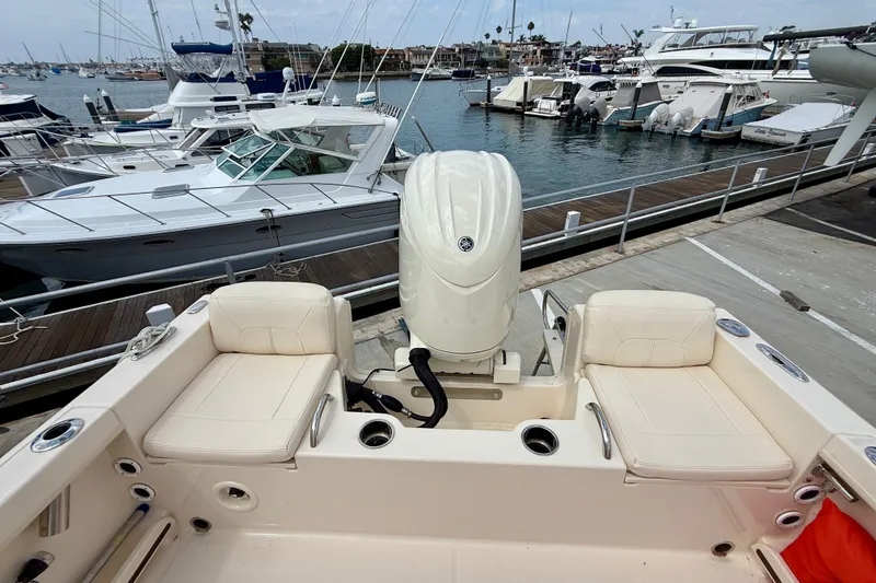 Slide: The Image of 2026 Grady-White Fisherman 180 boat docked, featuring comfortable seating and powerful outboard motor. - 25