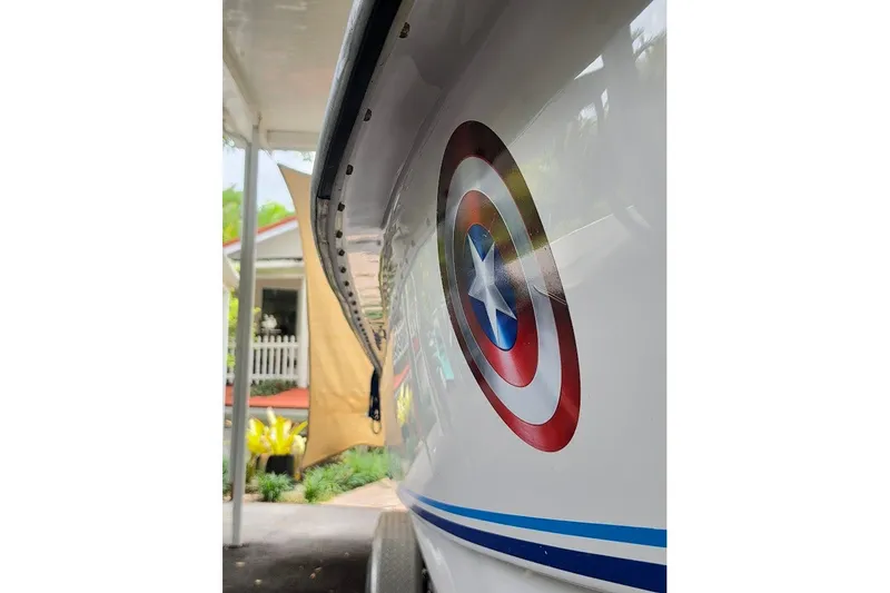 Slide: The Image of 2006 Twin Vee 26 Express boat with Captain America shield decal on the side. - 16