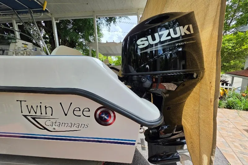 Slide: The Image of 2006 Twin Vee 26 Express catamaran with Suzuki outboard motor in a sunny setting. - 17
