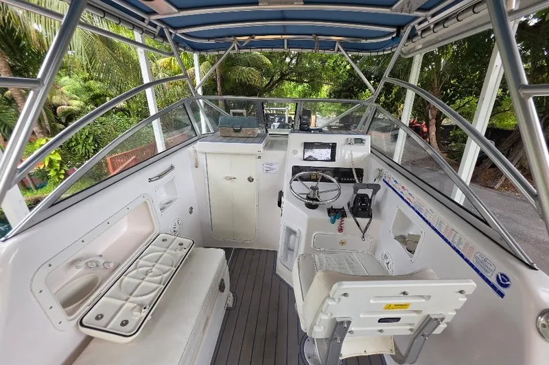 Slide: The Image of Interior view of a 2006 Twin Vee 26 Express boat cockpit with steering wheel and seating. - 25