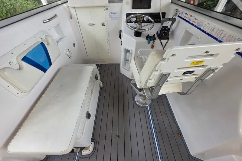 Slide: The Image of 2006 Twin Vee 26 Express boat interior with steering console and seating. - 43