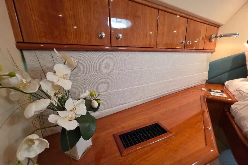 Slide: The Image of Luxurious Neptunus Flybridge MY 2008 interior with elegant wood cabinetry and floral decor. - 123