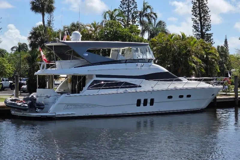 Slide: The Image of 2008 Neptunus Flybridge MY yacht docked by lush greenery and calm waters. - 1