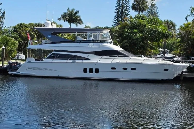 Slide: The Image of 2008 Neptunus Flybridge MY yacht docked on a serene waterway. - 2