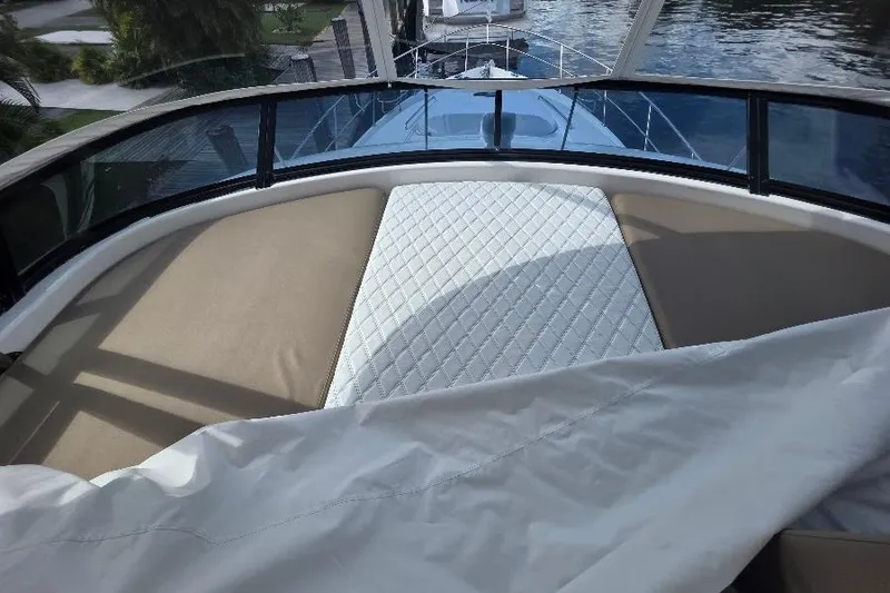 Slide: The Image of Flybridge view of 2008 Neptunus yacht with cushioned seating and water backdrop. - 35