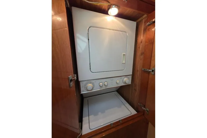 Slide: The Image of Stacked washer and dryer in 2008 Neptunus Flybridge MY yacht's wooden cabinet. - 105