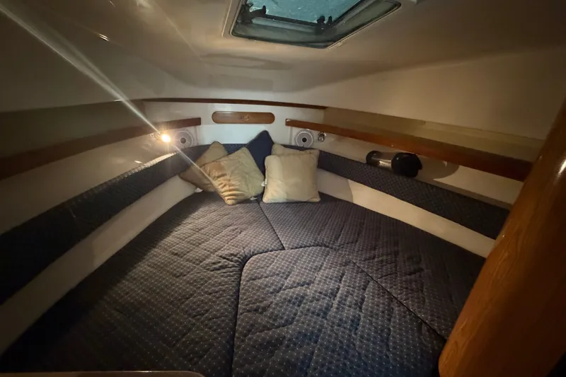 Slide: The Image of Cozy cabin interior of 2008 Pursuit OS 285 Offshore boat with cushions and lighting. - 18
