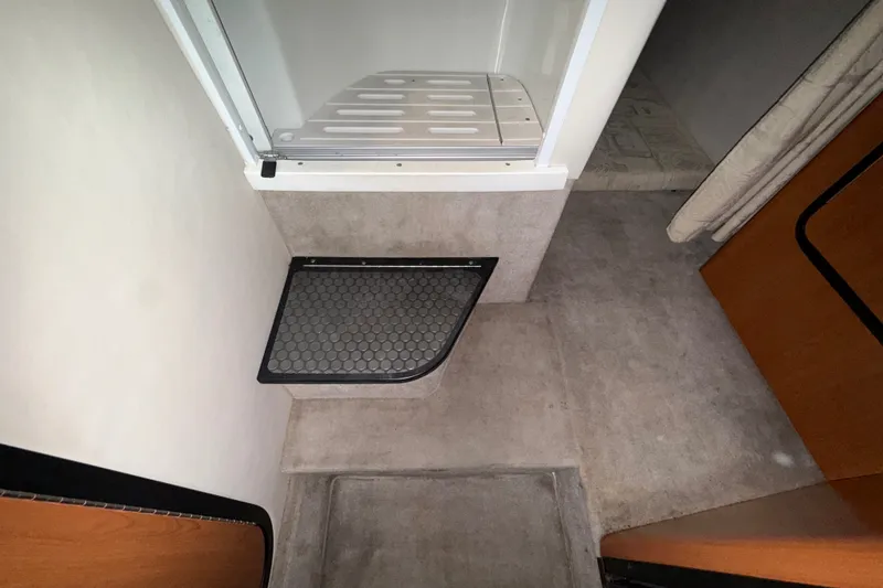 Slide: The Image of Interior of a 2005 Crownline 270 CR boat showing a compact shower area. - 43