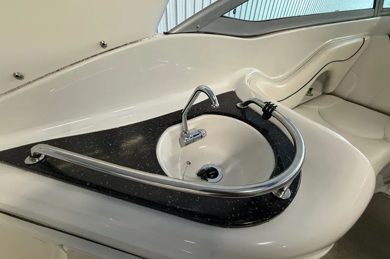 Slide: The Image of 2005 Crownline 270 CR boat interior with sleek sink and countertop design. - 14